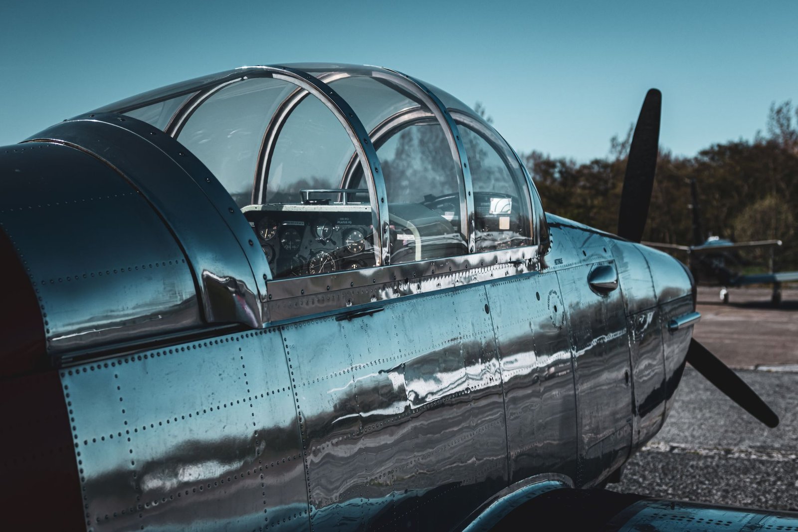 Mirror-polished aluminum fuselage and canopy reflecting the sky