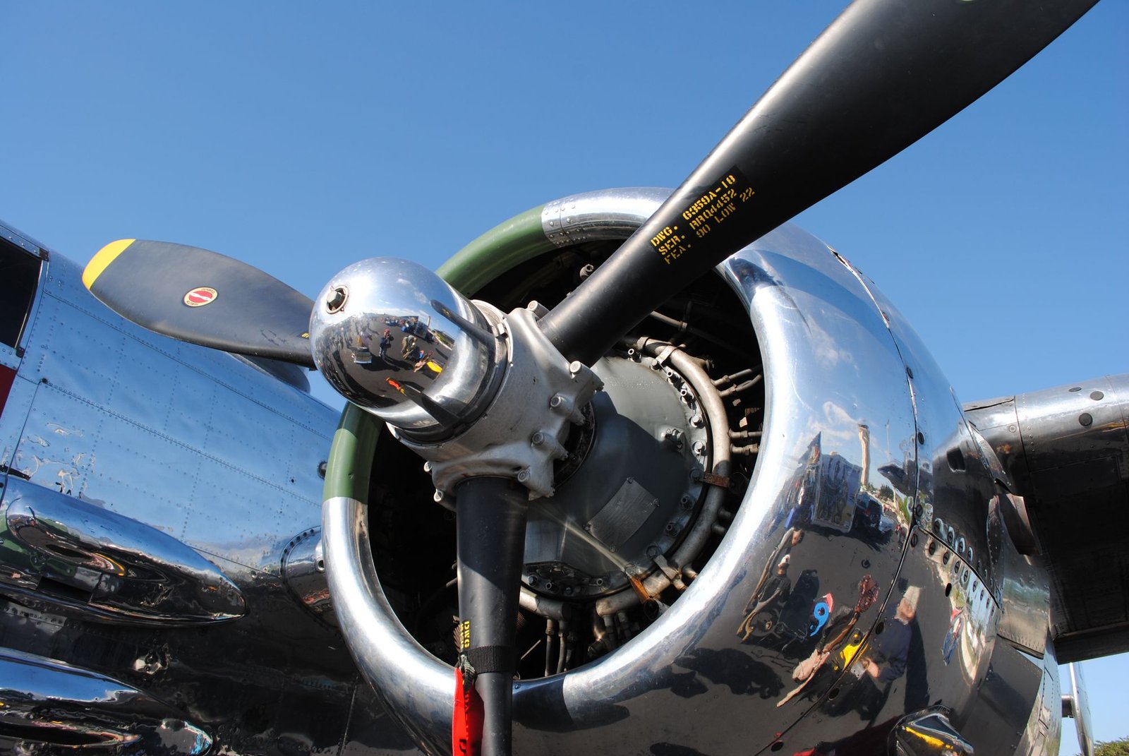 Polished radial engine cowling and propeller hub shining in the sun